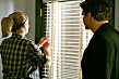 Kate shuts the door and the blinds