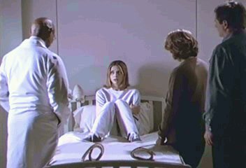 The Doctor, Joyce and Hank talk to Buffy who sits on her hospital bed
