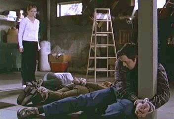 Buffy looks at tied up Xander, Willow and Dawn