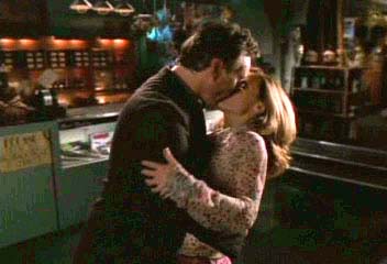 Giles and Anya kissing in the Magic Box